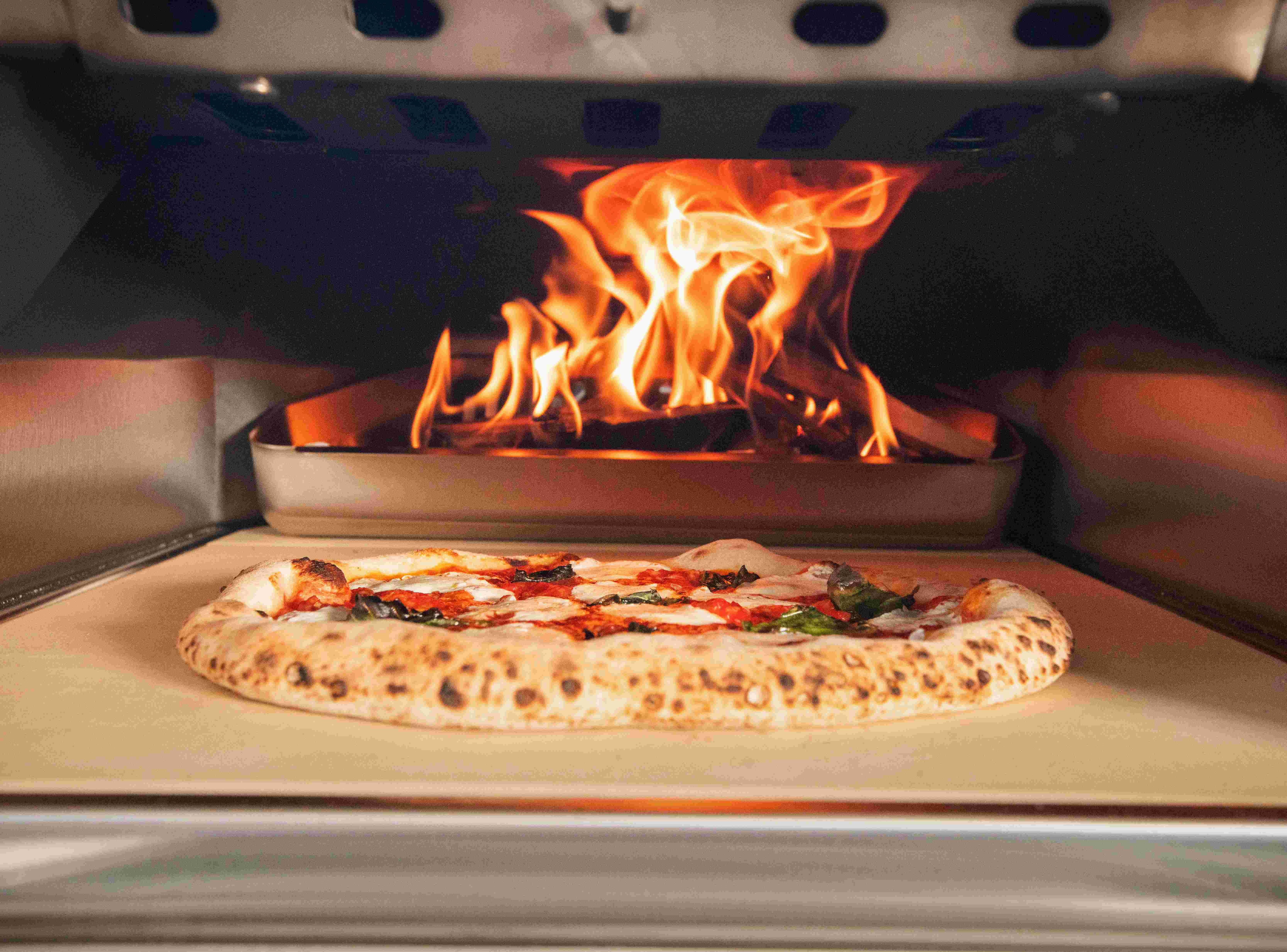 Pizza cooking inside Ooni Karu 16